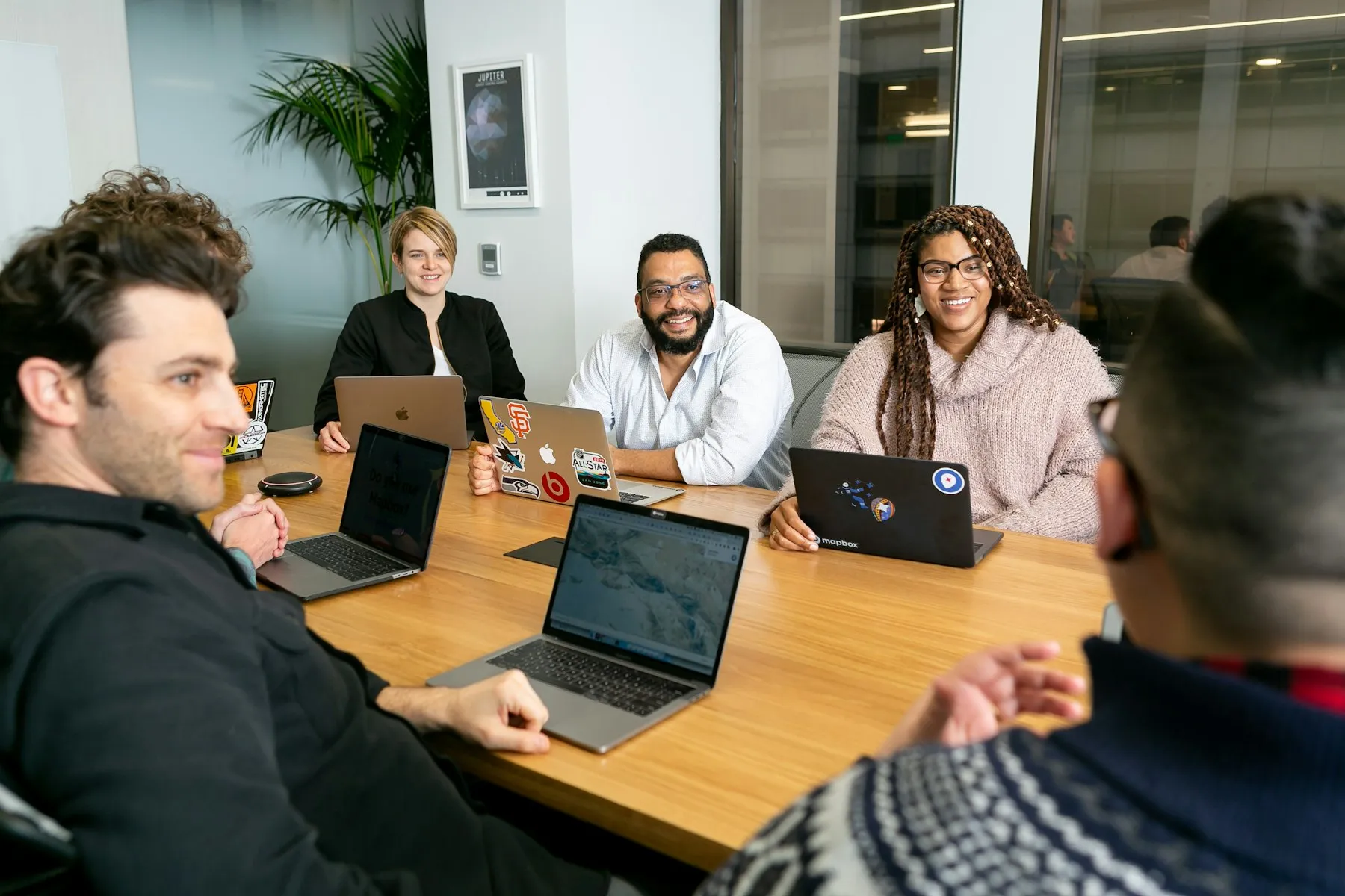 A team talking around a table with laptops