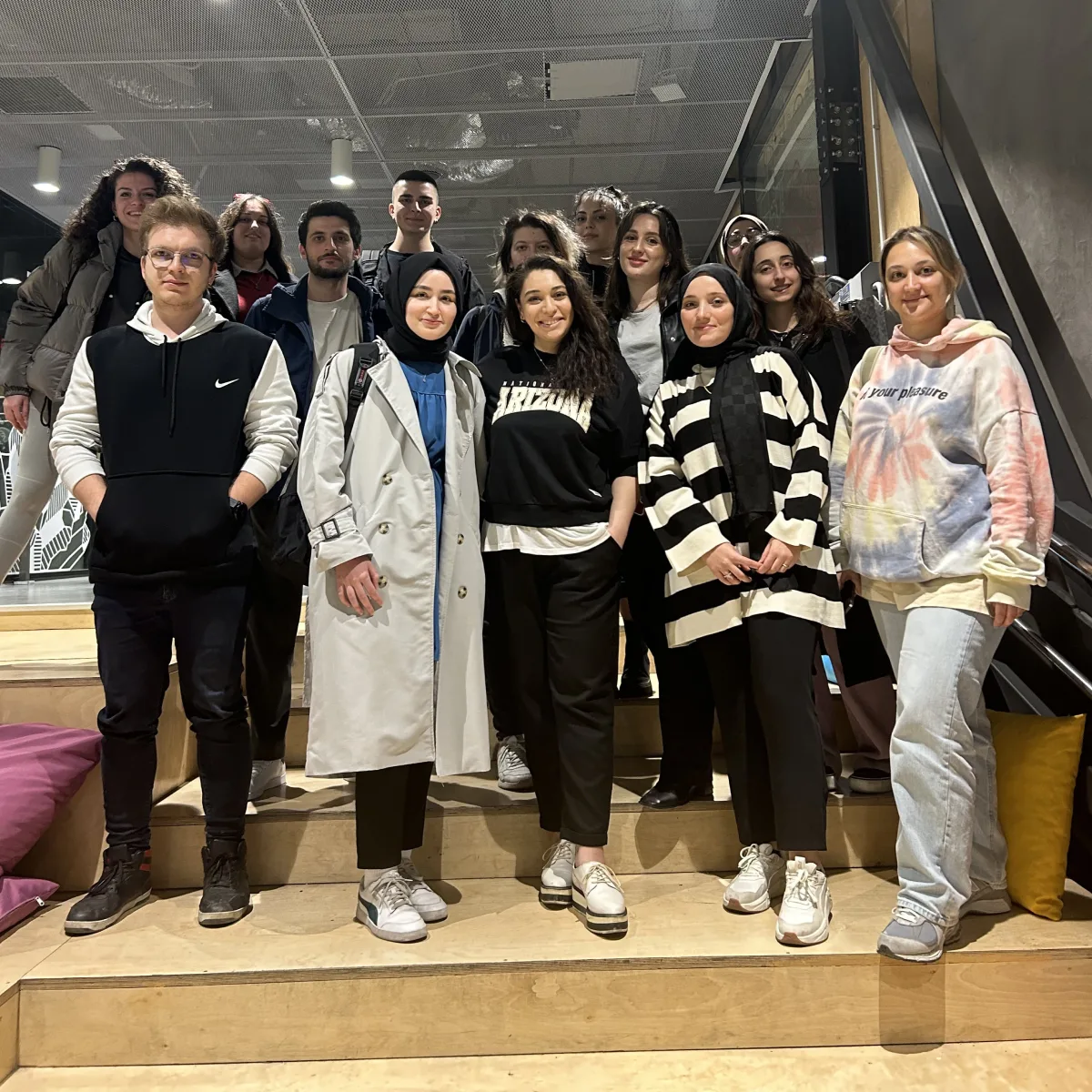 Participants posing on the stairs after a session